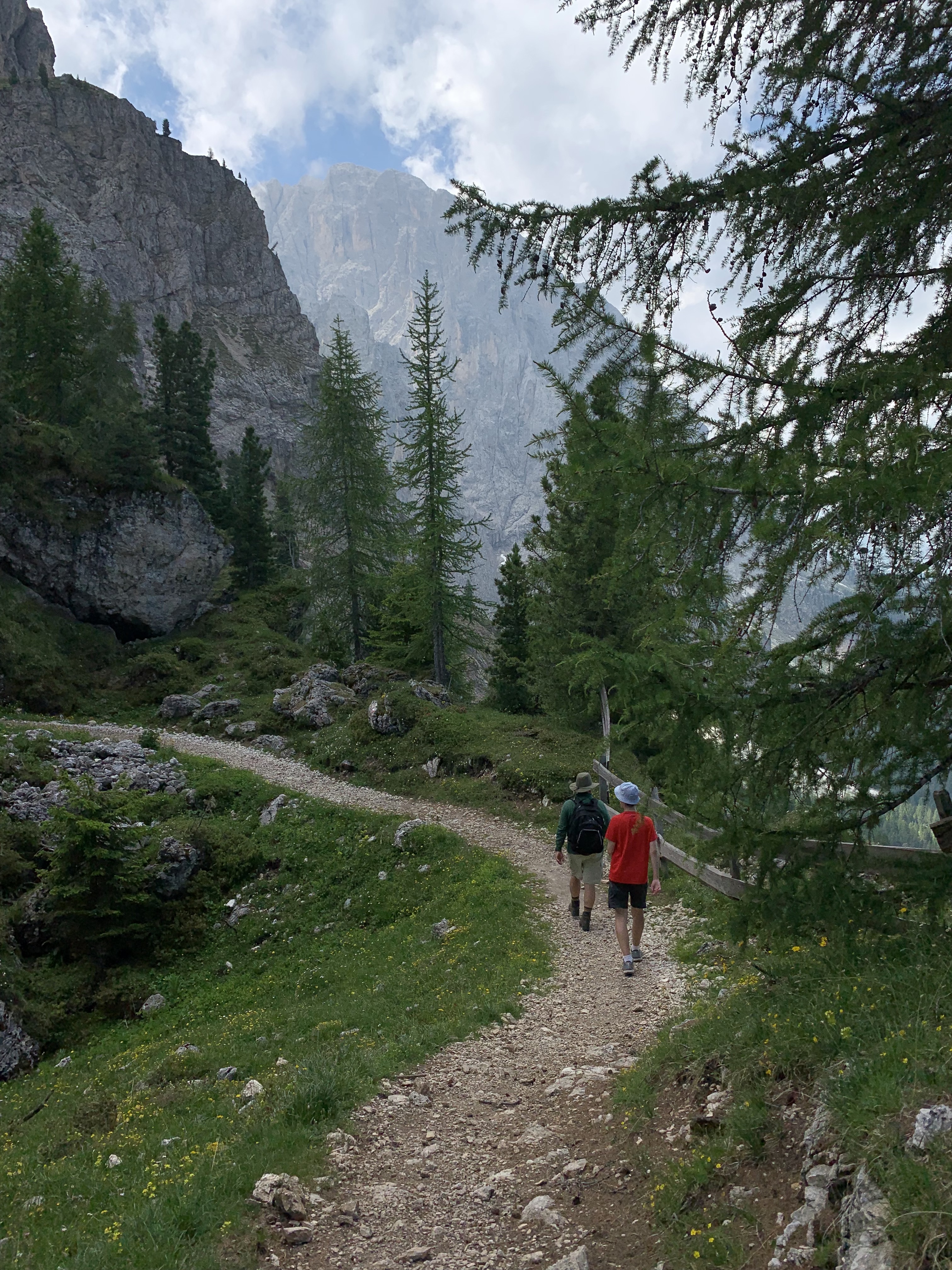 two hikers turn a corner on a trail